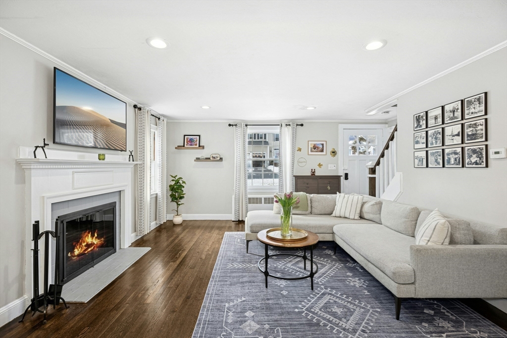 102 Spruce Street Framingham, MA 01701 - Photo 3 of 30 a living room with furniture a flat screen tv and a fireplace
