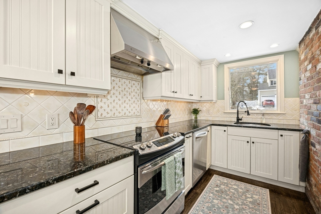 102 Spruce Street Framingham, MA 01701 - Photo 6 of 30 a kitchen with granite countertop a sink stainless steel appliances and cabinets