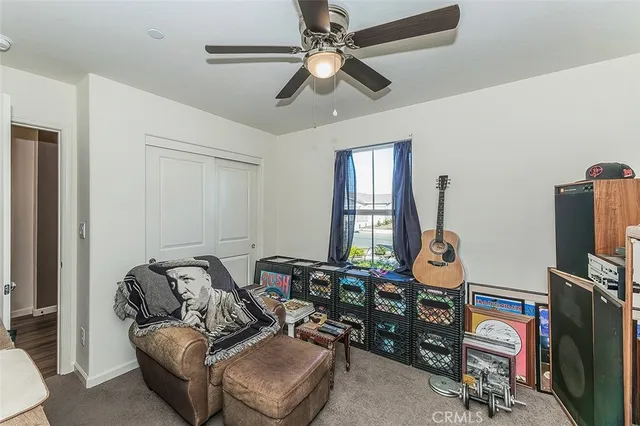 a living room with furniture a flat screen tv and a window