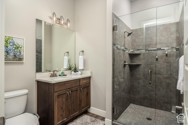 2600 Ocotillo Way, Unit 34 Santa Clara, UT 84765 - Photo 17 of 43 Bathroom with vanity, a stall shower, and dark wood-type flooring