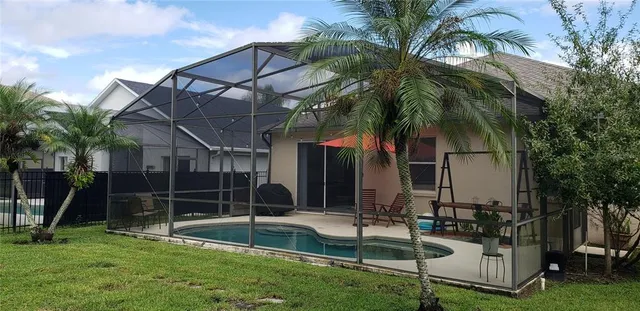 a view of house with a yard and entertaining space