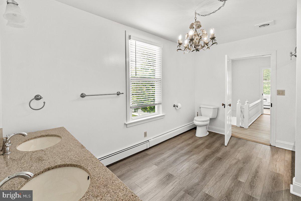 201 East Main Street Fairfield, PA 17320 - Photo 19 of 44 a spacious bedroom with a granite countertop toilet a sink and a mirror