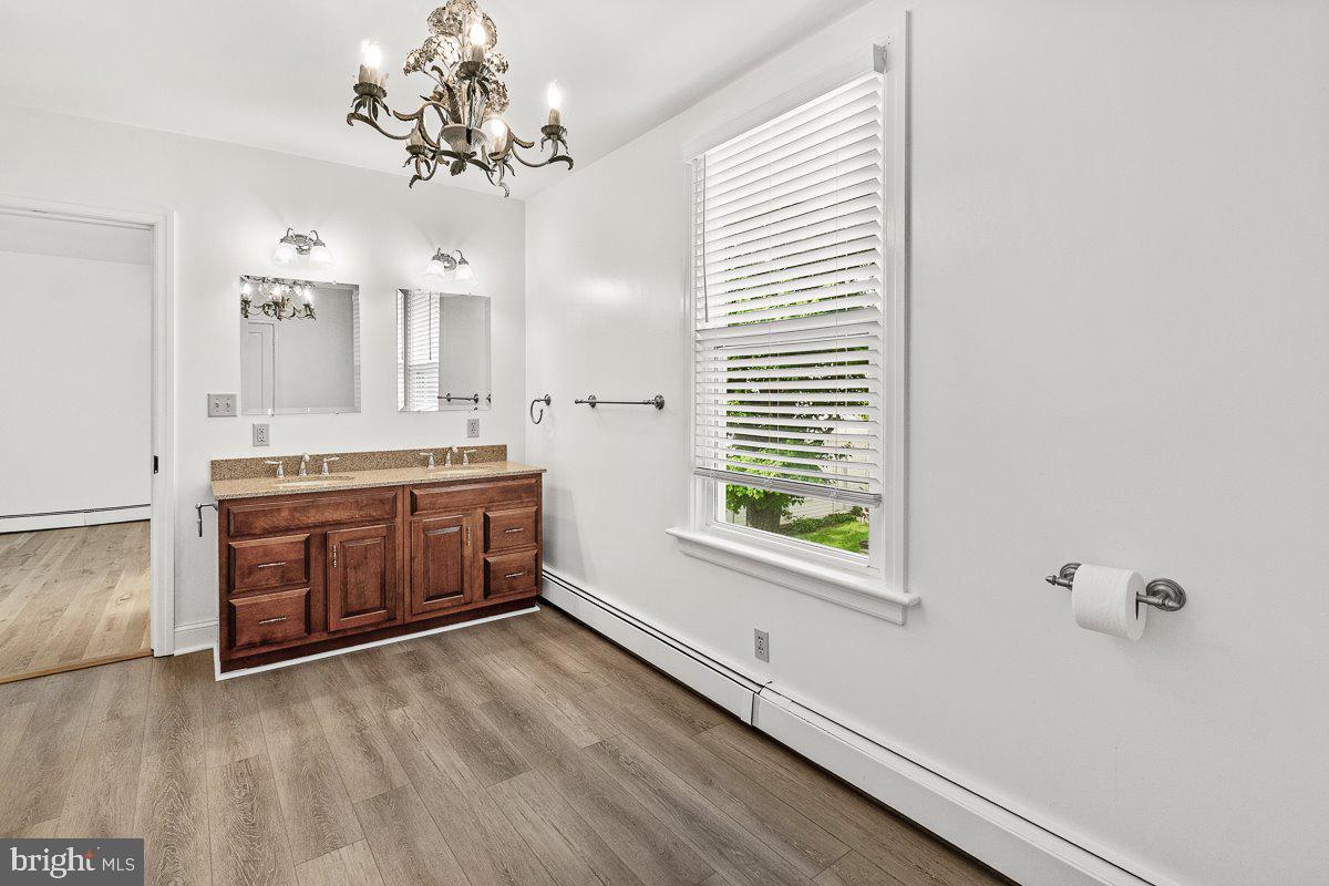 201 East Main Street Fairfield, PA 17320 - Photo 20 of 44 a bathroom with a double vanity sink a large mirror and a bathtub