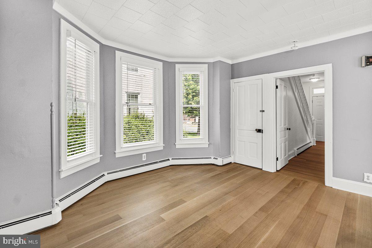 201 East Main Street Fairfield, PA 17320 - Photo 5 of 44 a view of an empty room with wooden floor and a window