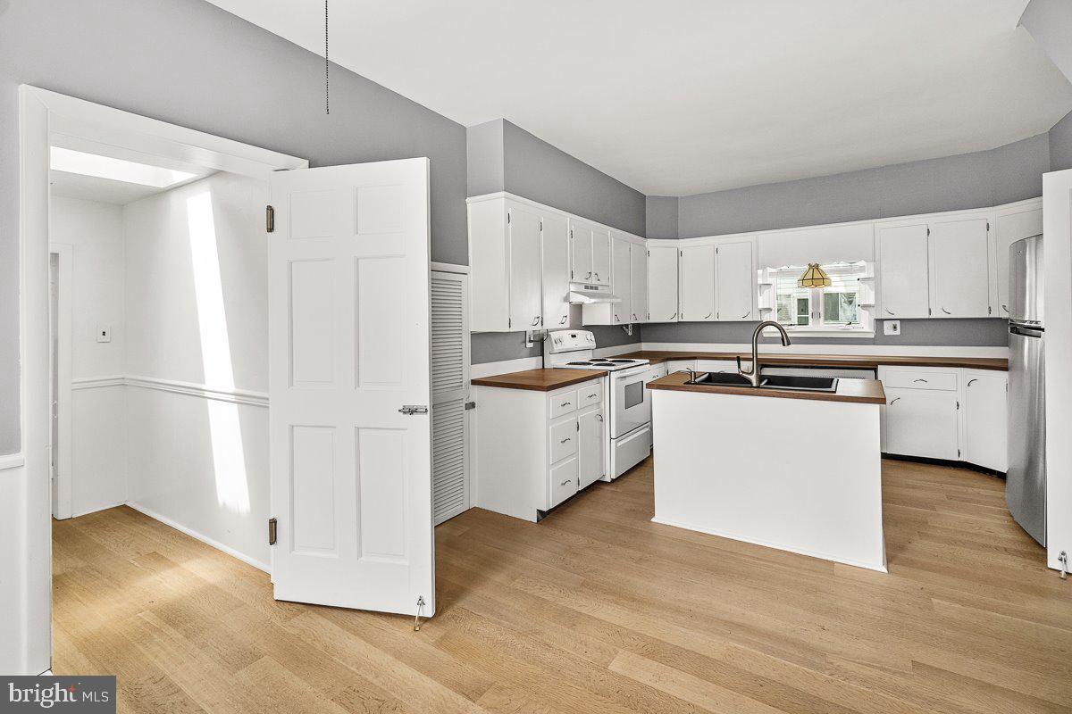 201 East Main Street Fairfield, PA 17320 - Photo 9 of 44 a kitchen with stainless steel appliances a refrigerator a sink and wooden floors