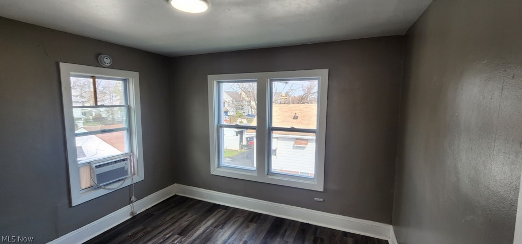 1514 Clermont Road Cleveland, OH 44110 - Photo 11 of 16 Spare room featuring dark wood finished floors and cooling unit