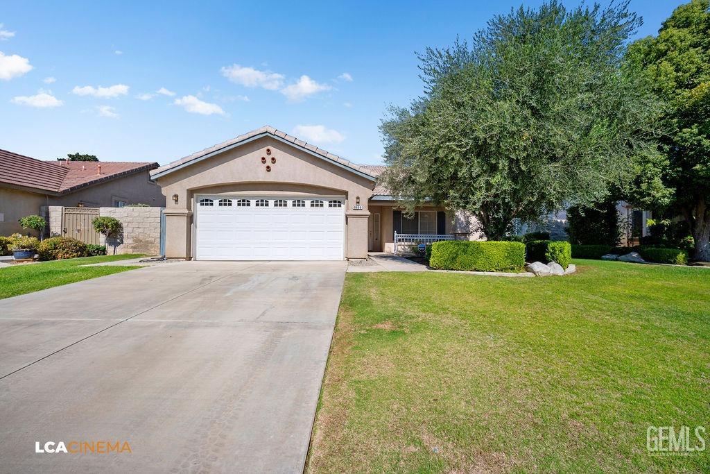a sign board with a big yard and large trees