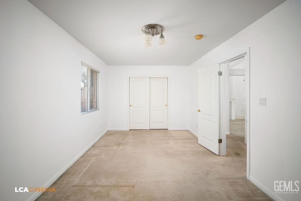Undisclosed Address Bakersfield, CA 93312 - Photo 12 of 23 an empty room with a ceiling fan and windows