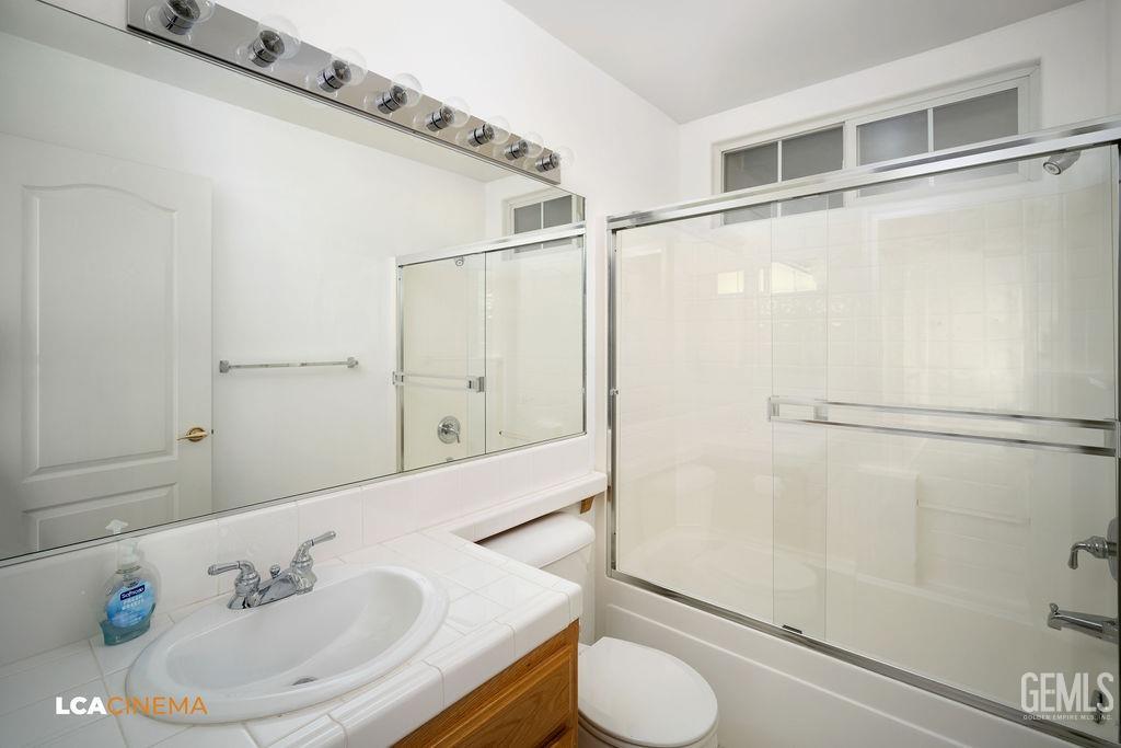 Undisclosed Address Bakersfield, CA 93312 - Photo 15 of 23 a bathroom with a sink and a mirror