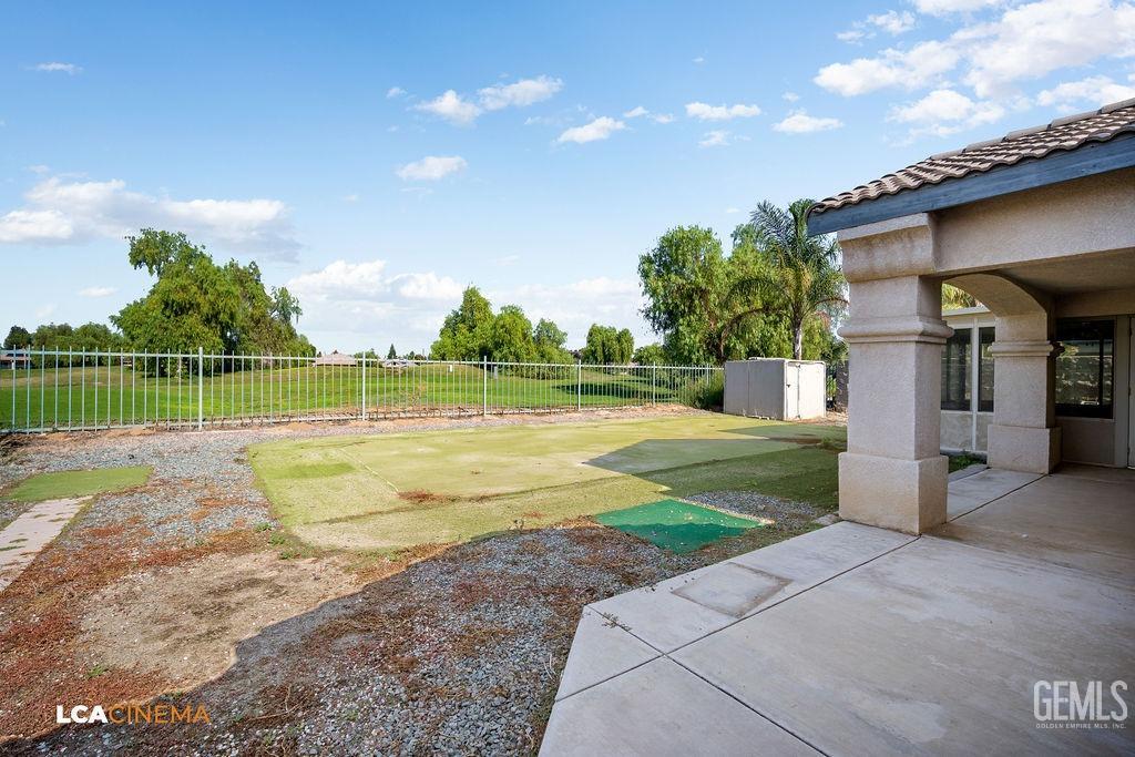 Undisclosed Address Bakersfield, CA 93312 - Photo 19 of 23 a view of a house with a swimming pool and a yard