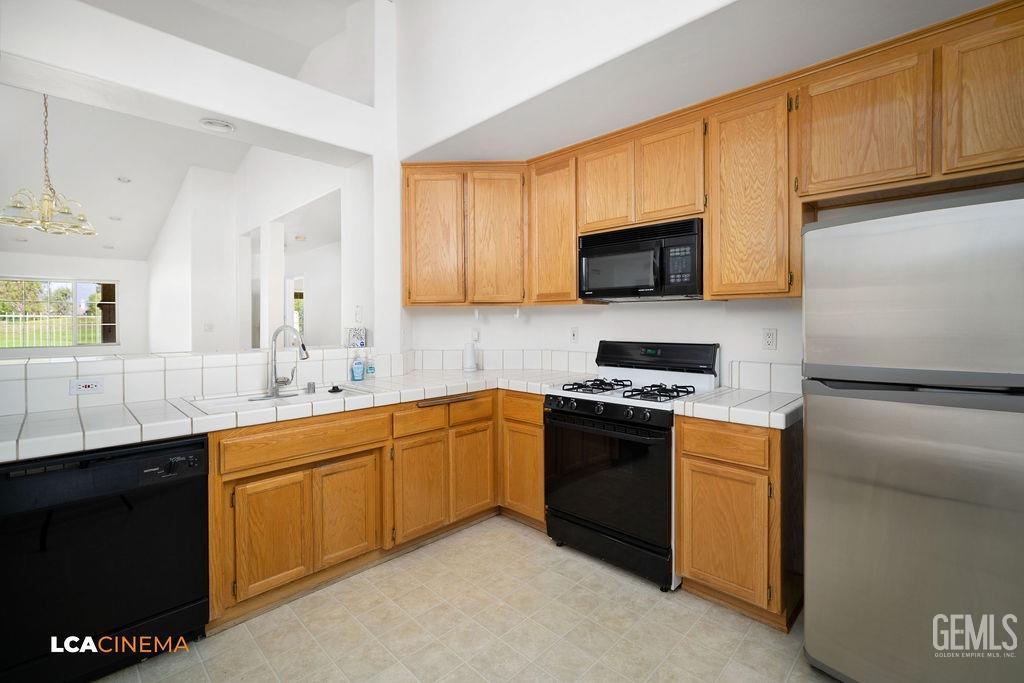 Undisclosed Address Bakersfield, CA 93312 - Photo 6 of 23 a kitchen with stainless steel appliances granite countertop a stove a sink and a microwave