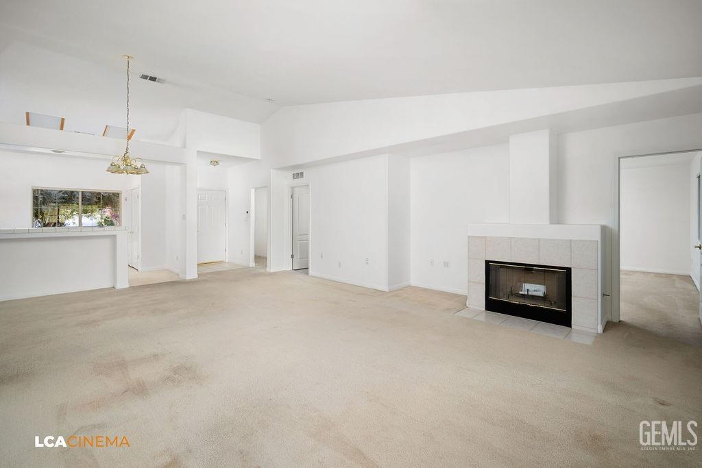 Undisclosed Address Bakersfield, CA 93312 - Photo 7 of 23 a view of an empty room with a fireplace