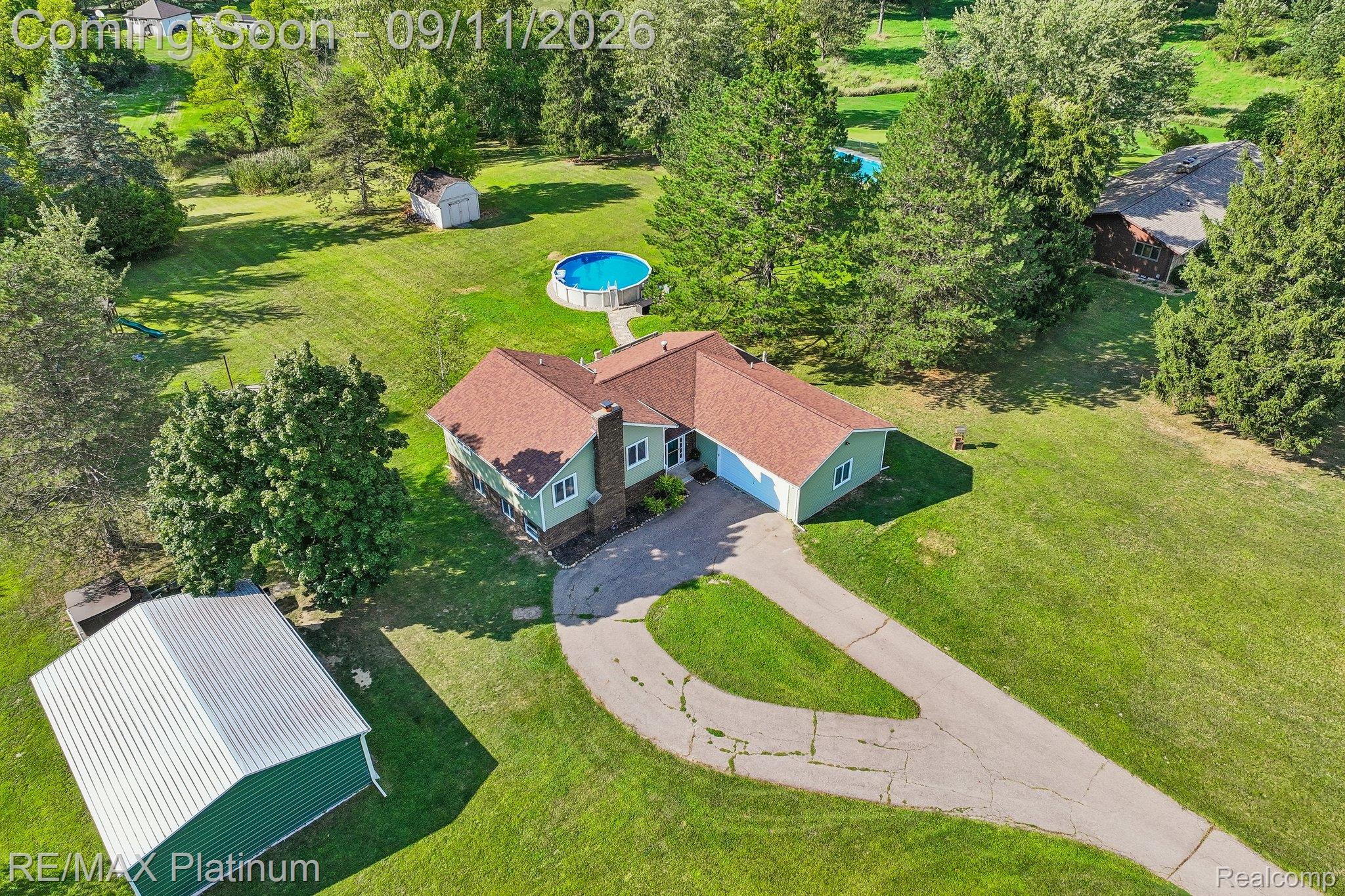 12126 Linden Road Linden, MI 48451 - Photo 2 of 38 Expansive property featuring a detached garage, circular driveway, above-ground pool, and a separate storage shed