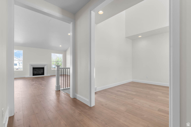 11749 South Halls Crk Road Draper, UT 84020 - Photo 6 of 21 Hallway with recessed lighting, light wood finished floors, vaulted ceiling, and an upstairs landing