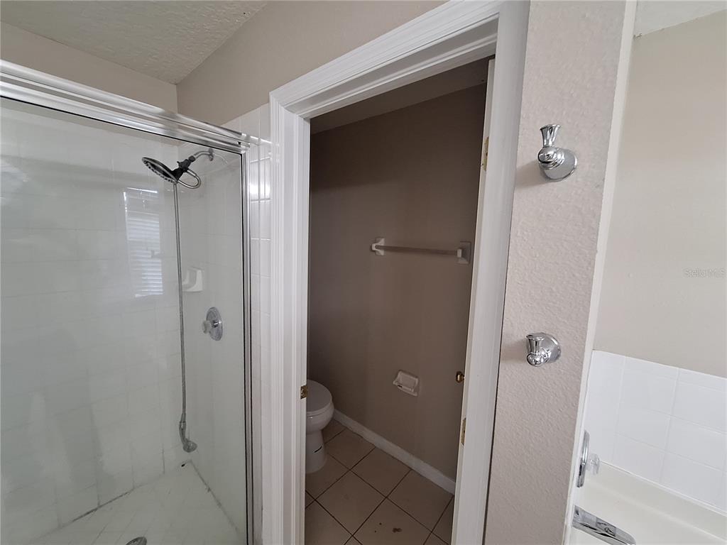27854 Breakers Drive Zephyrhills, FL 33544 - Photo 12 of 16 a bathroom with a granite countertop shower mirror and a sink