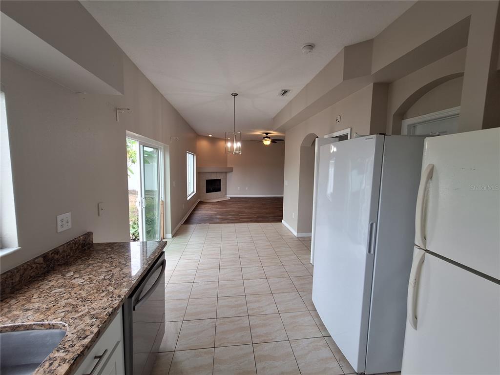 27854 Breakers Drive Zephyrhills, FL 33544 - Photo 4 of 16 a view of a refrigerator in kitchen and a kitchen