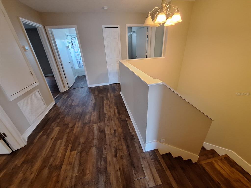 27854 Breakers Drive Zephyrhills, FL 33544 - Photo 6 of 16 a view of a hallway with wooden floor and staircase