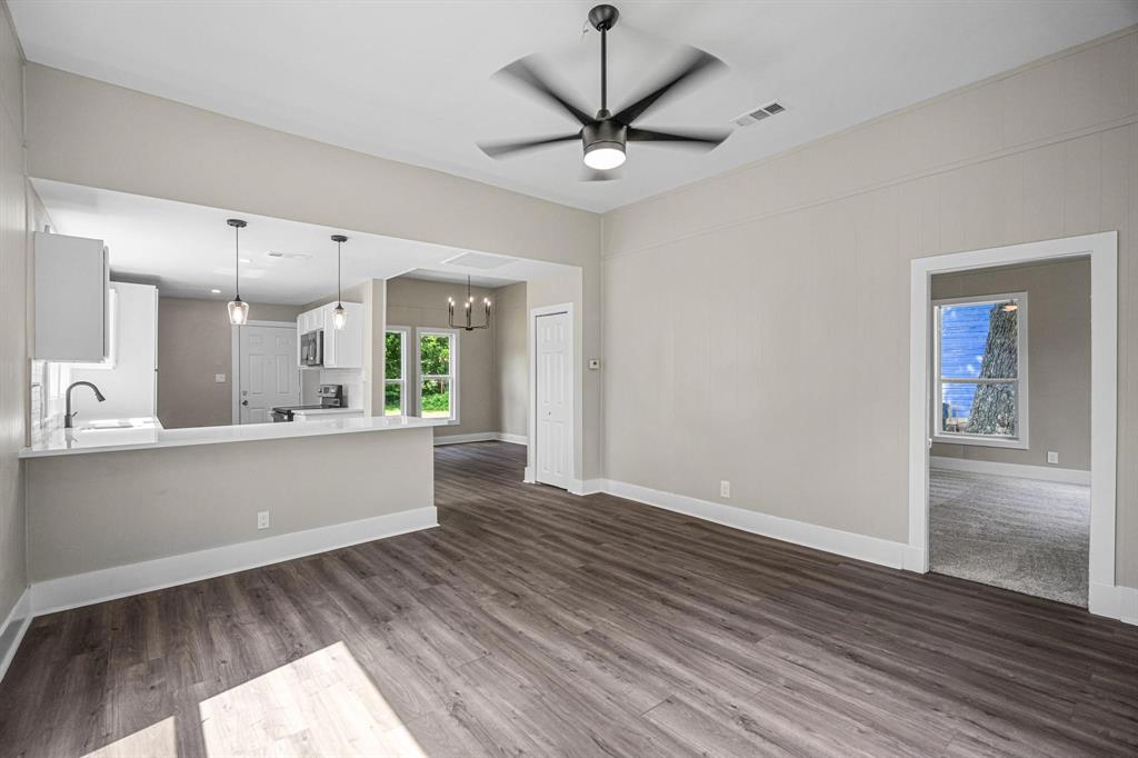 827 West Ellis Street Sherman, TX 75092 - Photo 3 of 5 a living room with wooden floor and a ceiling fan