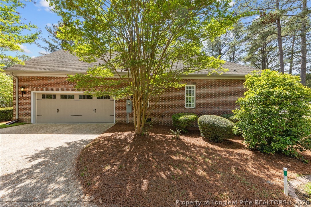 30180 East Lake Road Wagram, NC 28396 - Photo 39 of 42 a backyard of a house with garage and a tree