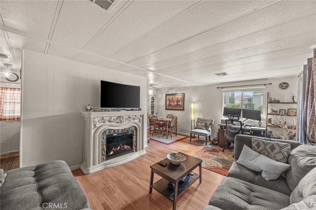 5700 Carbon Canyon Road, Unit 42 Brea, CA 92823 - Photo 1 of 23 a living room with furniture a flat screen tv and a fireplace