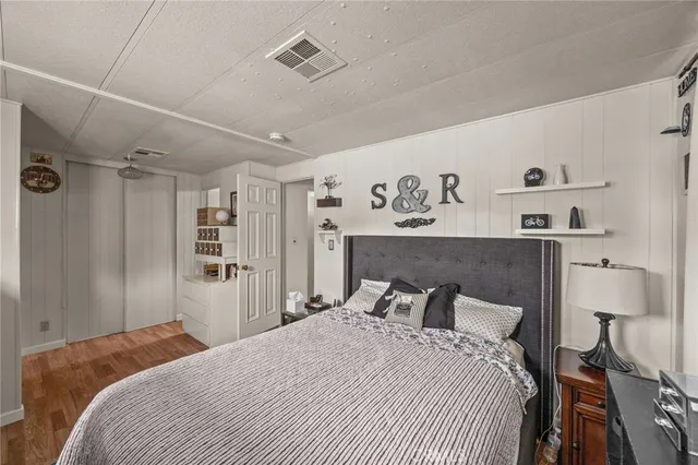 a bedroom with a large bed and a chandelier
