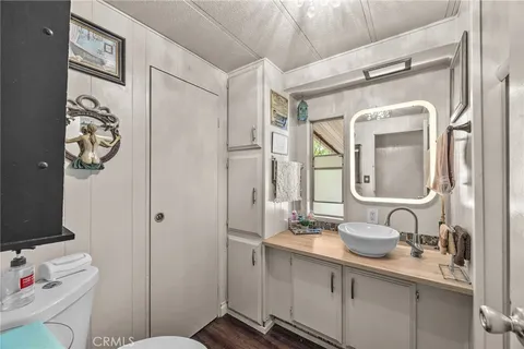 a bathroom with a sink vanity and mirror