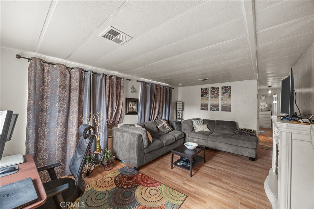 5700 Carbon Canyon Road, Unit 42 Brea, CA 92823 - Photo 6 of 23 a living room with furniture a flat screen tv and a window