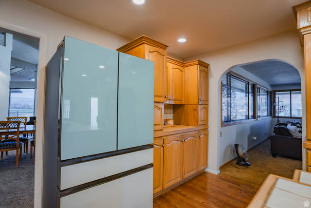 980 Cactus Circle St. George, UT 84790 - Photo 10 of 77 Kitchen with freestanding refrigerator, light countertops, dark wood-style flooring, and arched walkways