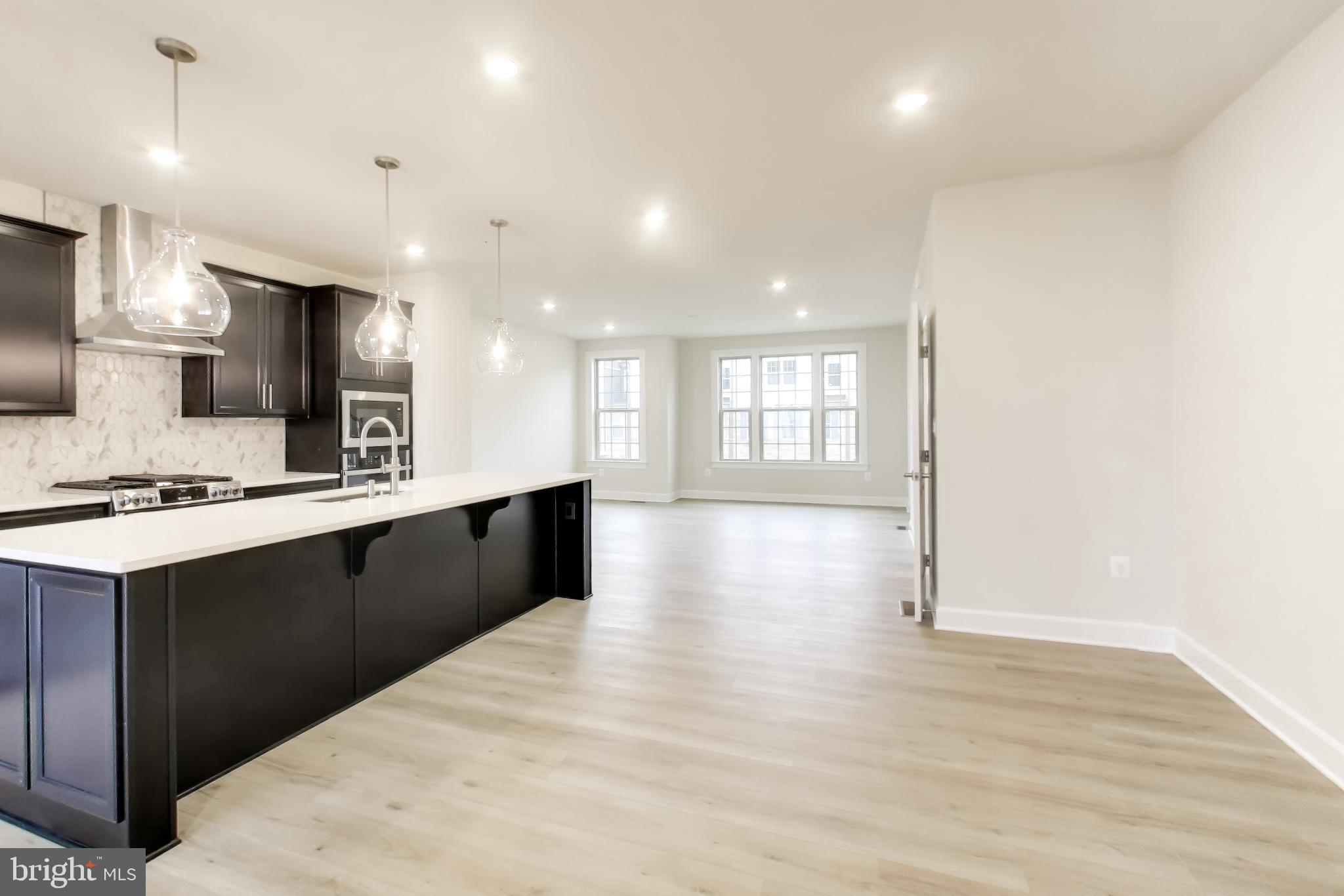 1774 Mill Branch Drive Laurel, MD 20708 - Photo 12 of 42 a large kitchen with a large counter top appliances and cabinets