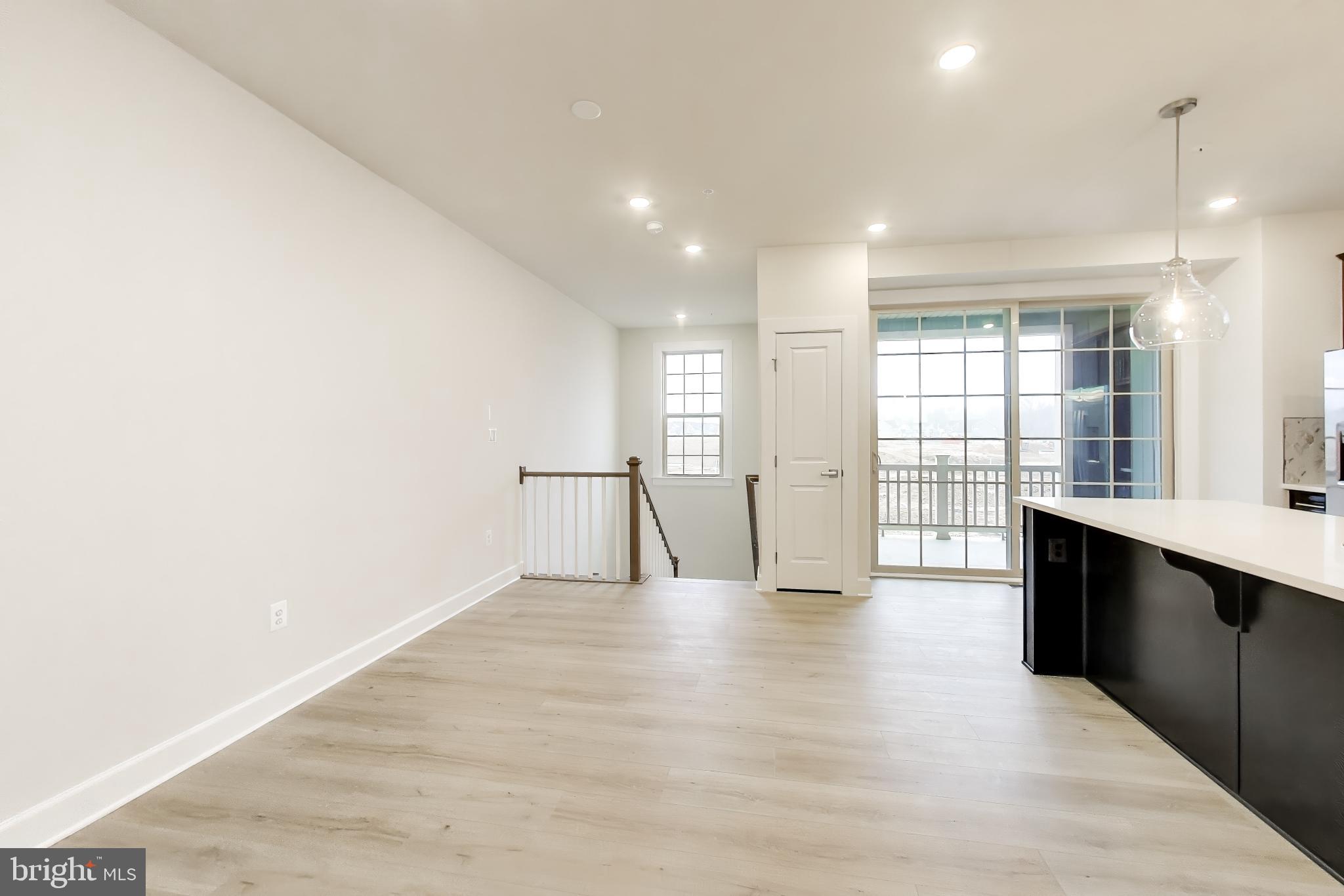1774 Mill Branch Drive Laurel, MD 20708 - Photo 13 of 42 a view of an empty room with wooden floor and a window
