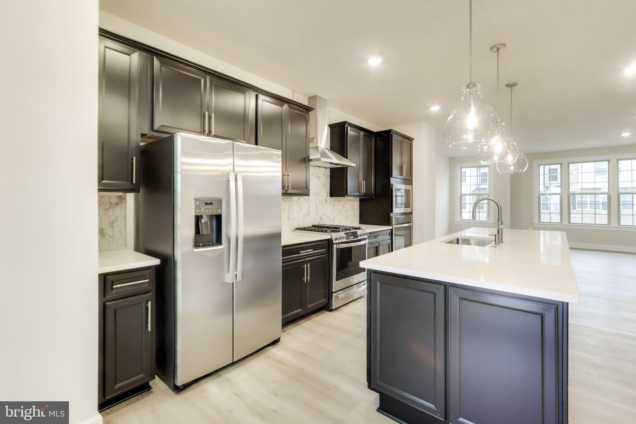 1774 Mill Branch Drive Laurel, MD 20708 - Photo 16 of 42 a kitchen with kitchen island a counter top space stainless steel appliances and cabinets