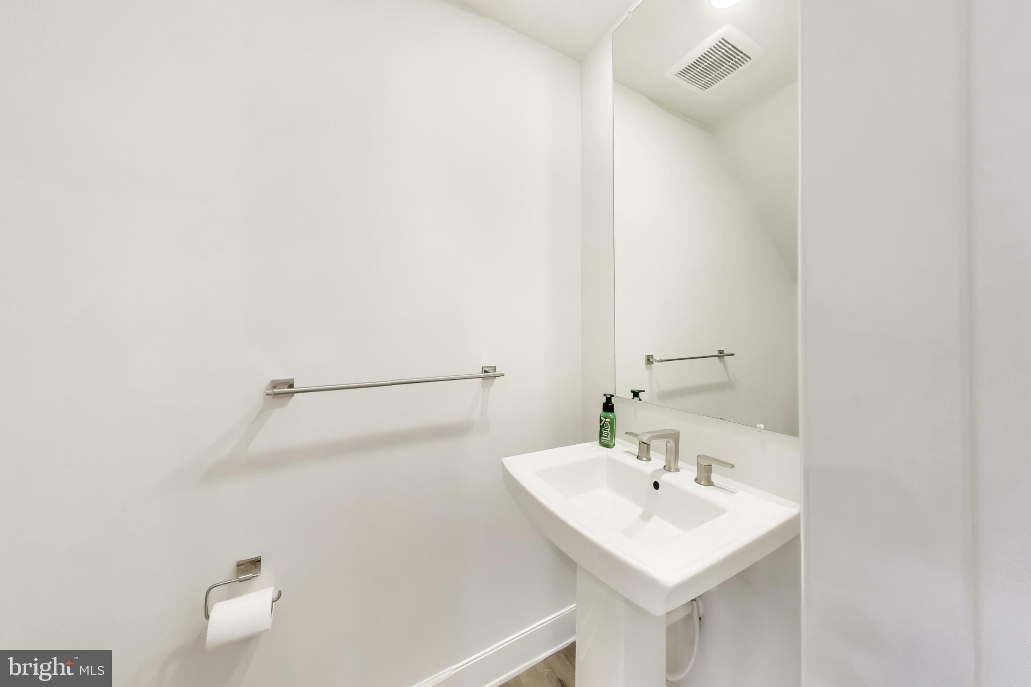 1774 Mill Branch Drive Laurel, MD 20708 - Photo 17 of 42 a bathroom with a sink and a mirror