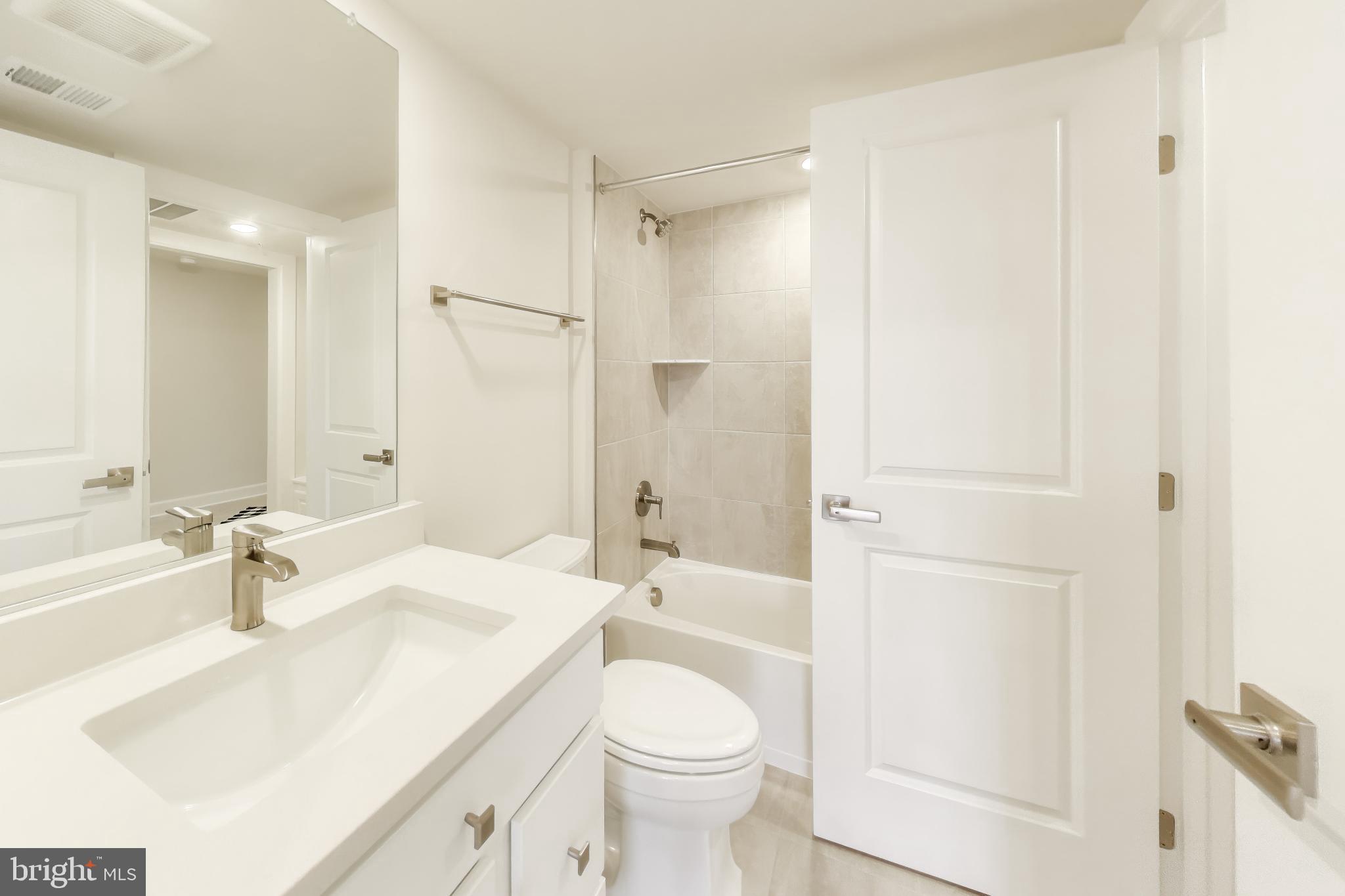 1774 Mill Branch Drive Laurel, MD 20708 - Photo 7 of 42 a bathroom with a sink toilet and shower