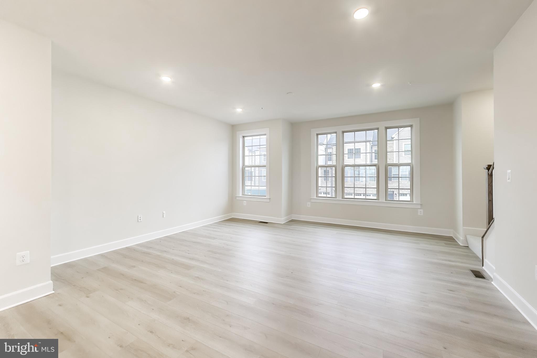 1774 Mill Branch Drive Laurel, MD 20708 - Photo 9 of 42 an empty room with wooden floor and windows