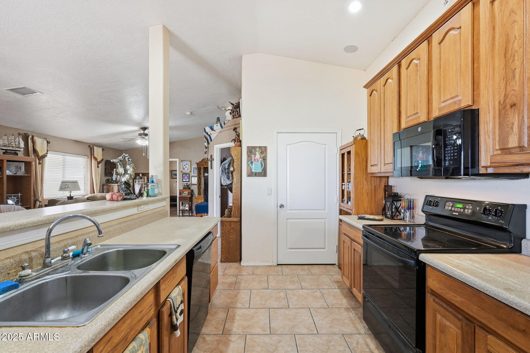 53607 West Moondust Road Maricopa, AZ 85139 - Photo 11 of 38 a kitchen with a sink stove top oven and refrigerator