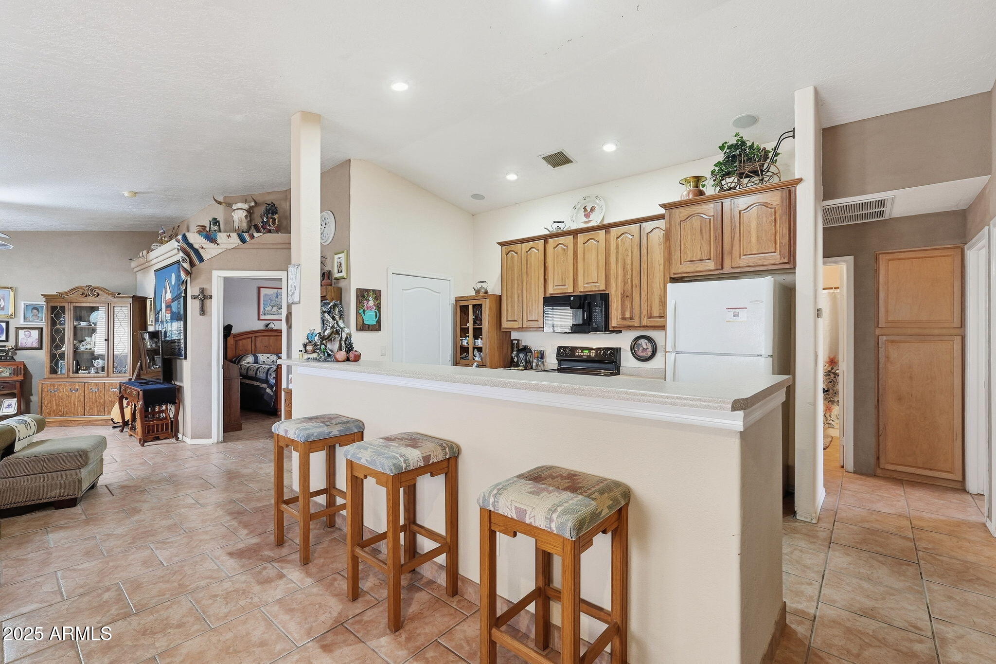 53607 West Moondust Road Maricopa, AZ 85139 - Photo 12 of 38 a kitchen with stainless steel appliances a refrigerator a stove a sink a dining table and chairs