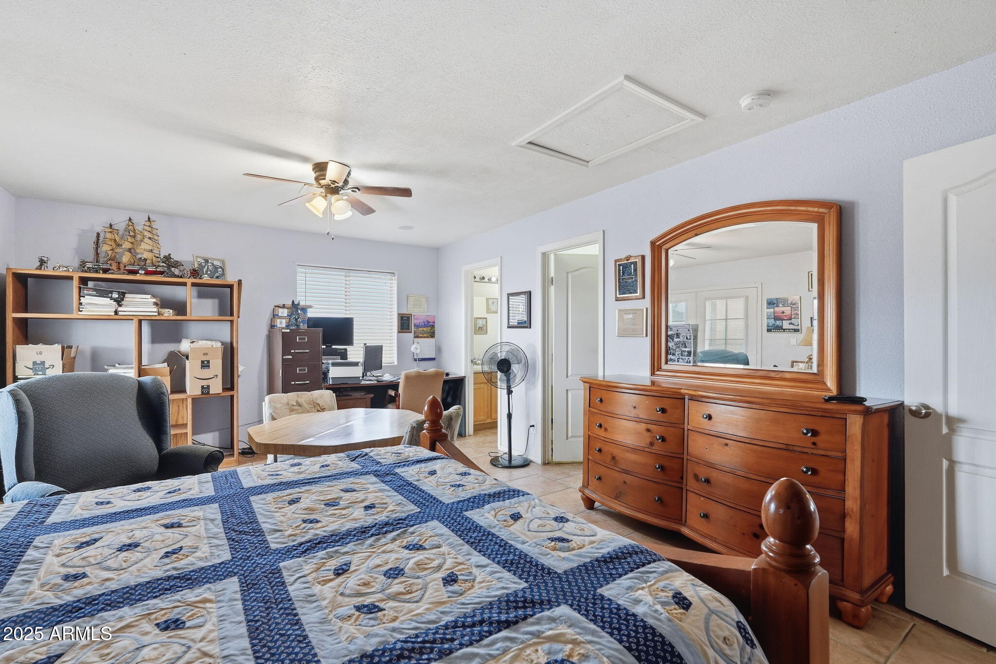 53607 West Moondust Road Maricopa, AZ 85139 - Photo 20 of 38 a bedroom with furniture and a chandelier