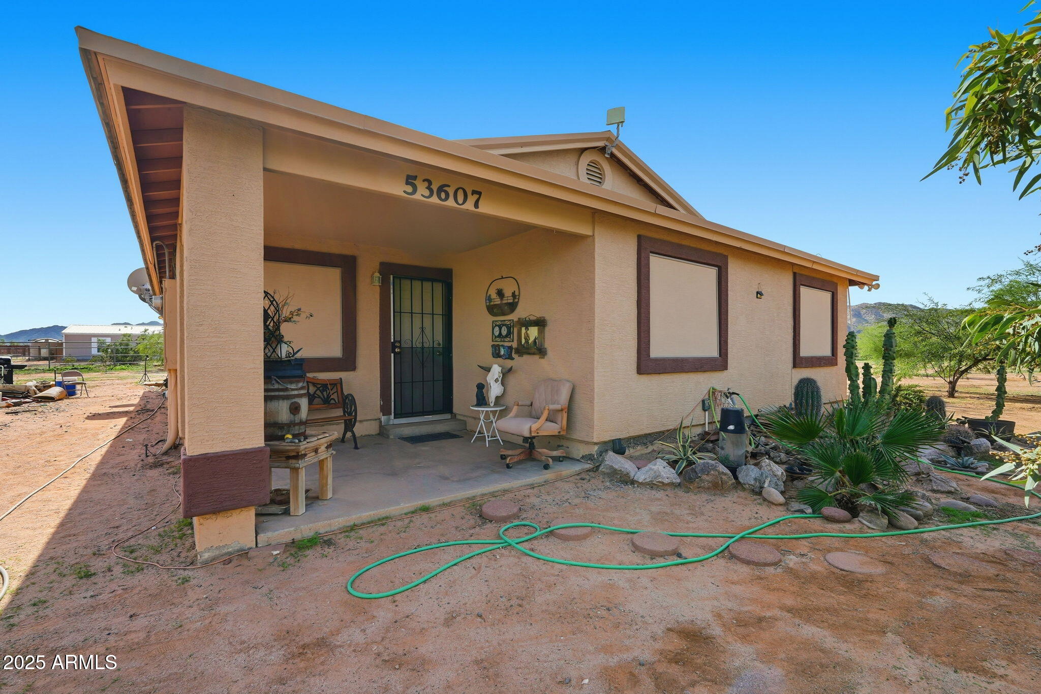 53607 West Moondust Road Maricopa, AZ 85139 - Photo 2 of 38 a view of a house with backyard and sitting area