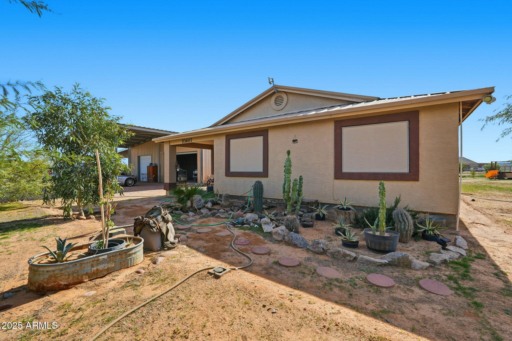 53607 West Moondust Road Maricopa, AZ 85139 - Photo 3 of 38 a view of a house with backyard and sitting area