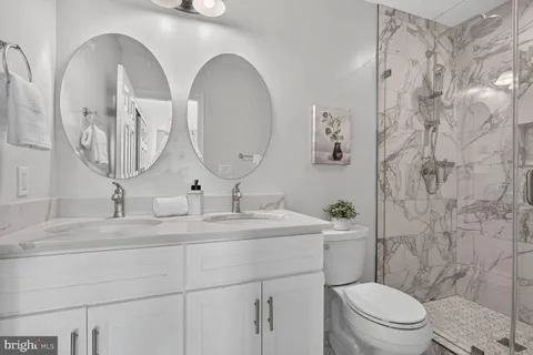 a bathroom with a toilet a sink and mirror