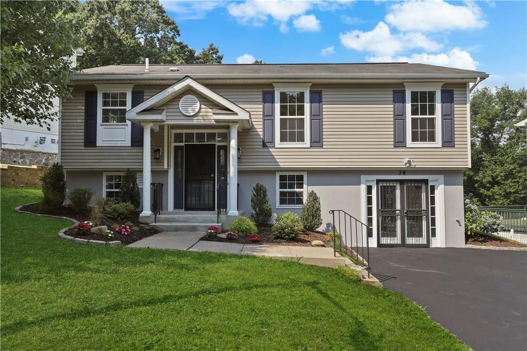 Bi-level home featuring a front lawn