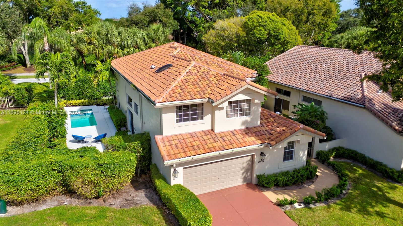 2609 Northwest 53rd Drive Boca Raton, FL 33496 - Photo 1 of 78 an aerial view of a house with a yard and plants