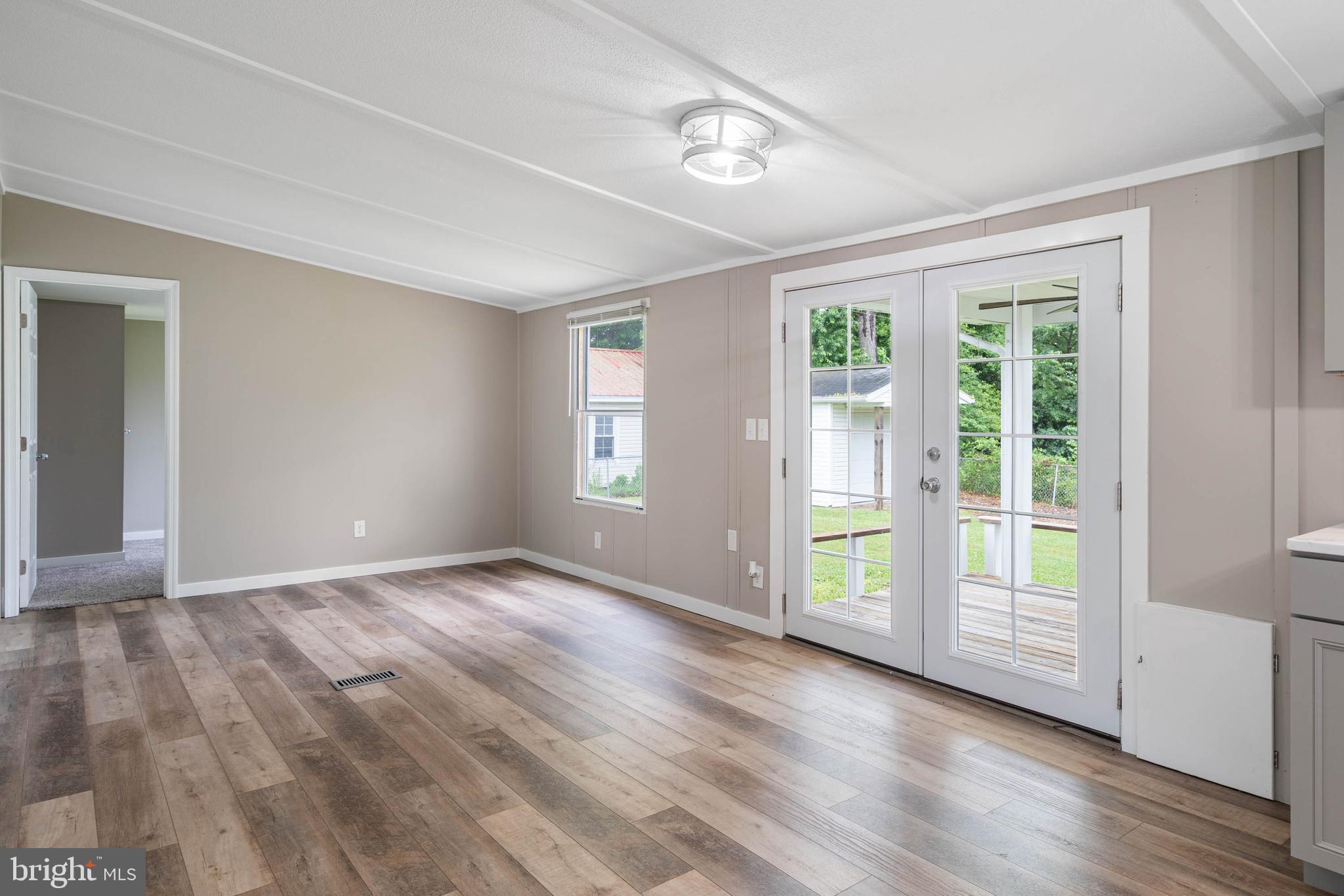 31392 Oak Street Ocean View, DE 19970 - Photo 16 of 38 a view of an empty room with wooden floor and a window