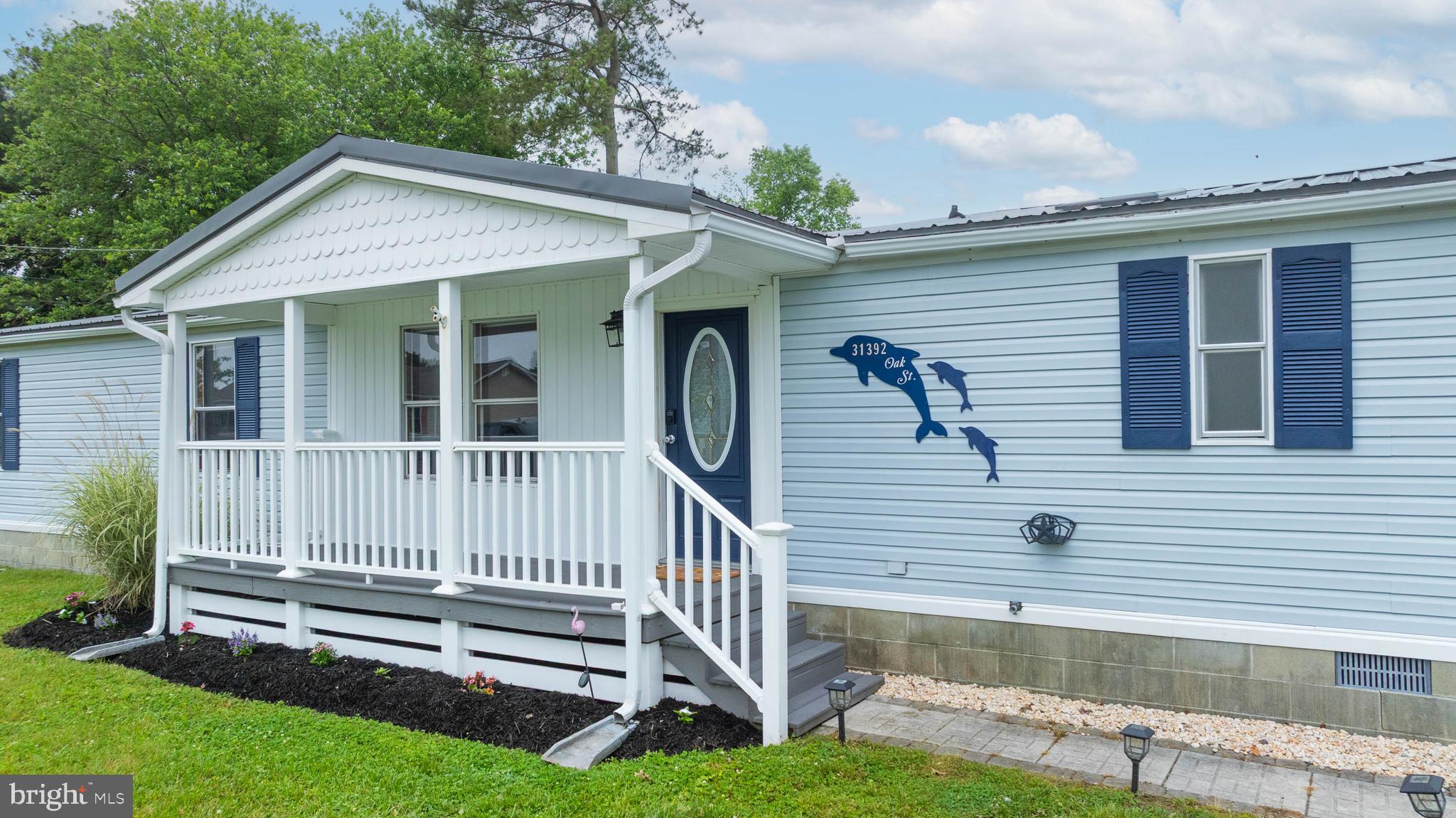 31392 Oak Street Ocean View, DE 19970 - Photo 3 of 38 a front view of a house with a yard
