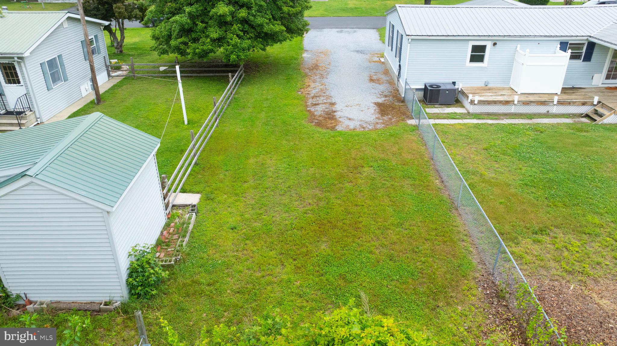 31392 Oak Street Ocean View, DE 19970 - Photo 33 of 38 a backyard of a house with table and chairs