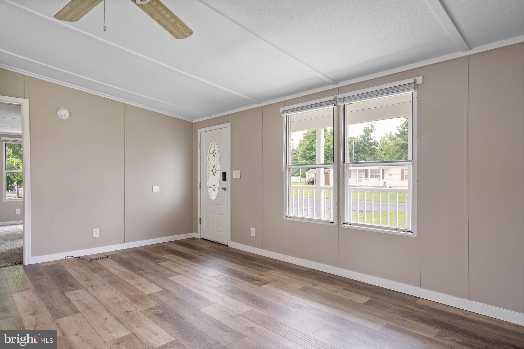 31392 Oak Street Ocean View, DE 19970 - Photo 7 of 38 an empty room with wooden floor and windows