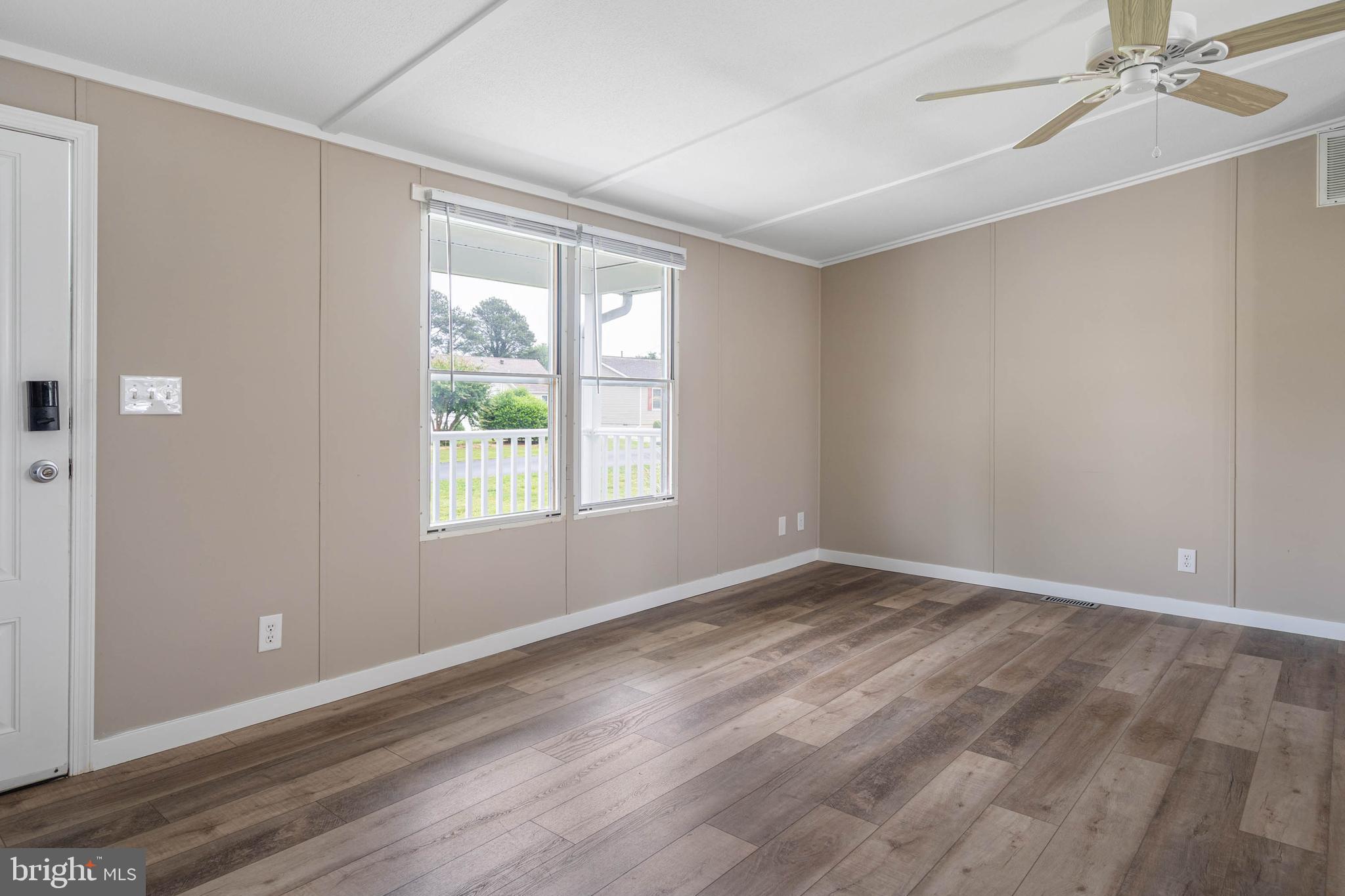 31392 Oak Street Ocean View, DE 19970 - Photo 8 of 38 a view of an empty room with wooden floor and a window