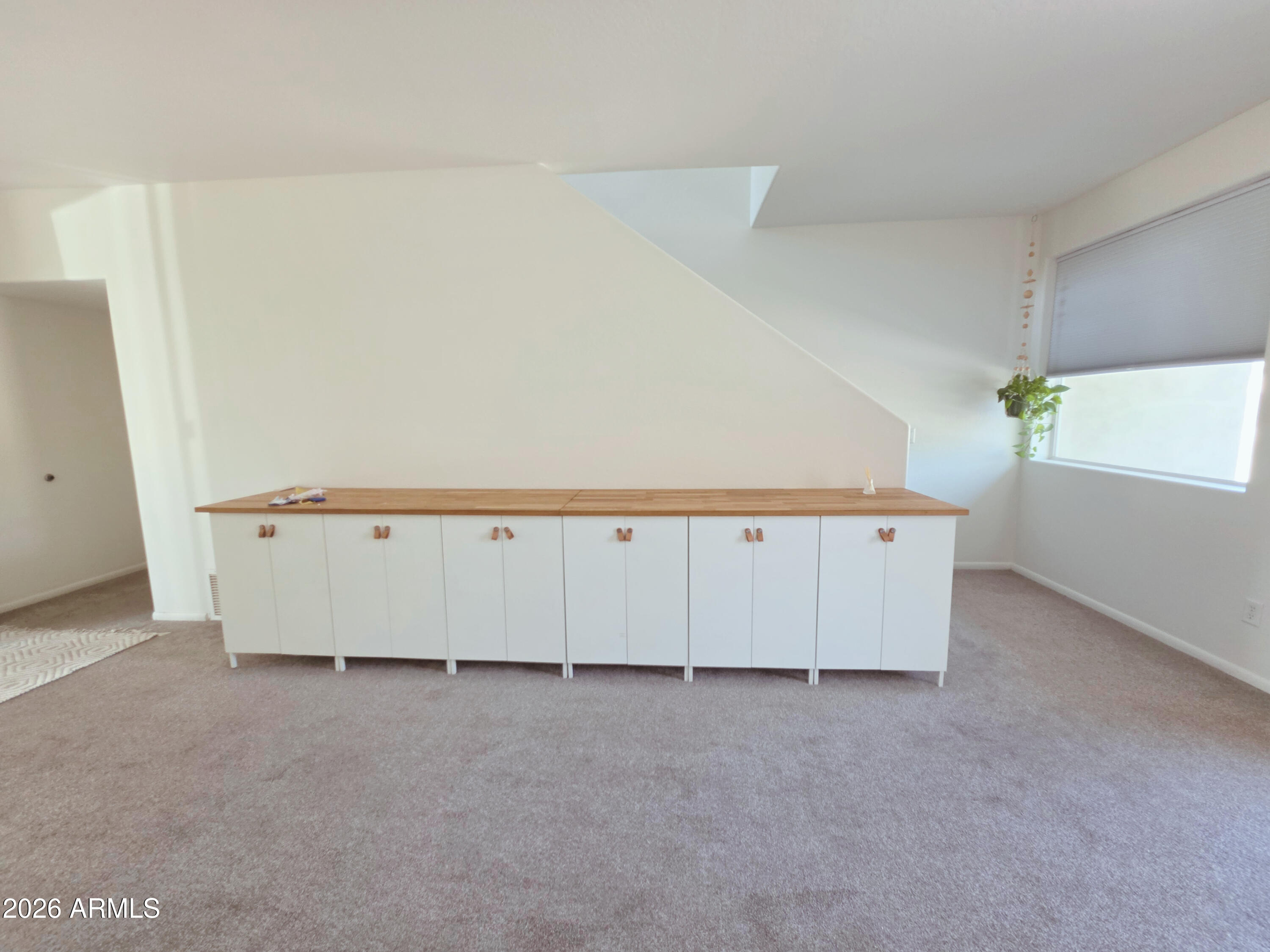 933 West Mercer Lane Phoenix, AZ 85029 - Photo 11 of 46 an empty room with a wooden floor and cabinet