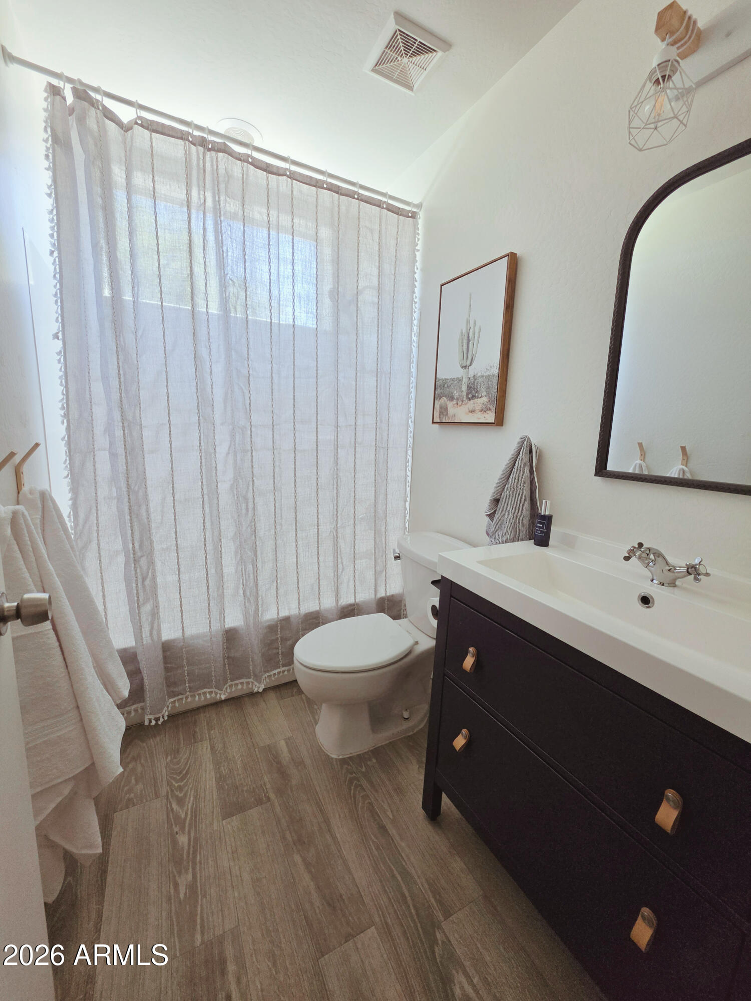 933 West Mercer Lane Phoenix, AZ 85029 - Photo 16 of 46 a bathroom with a toilet a sink and a mirror