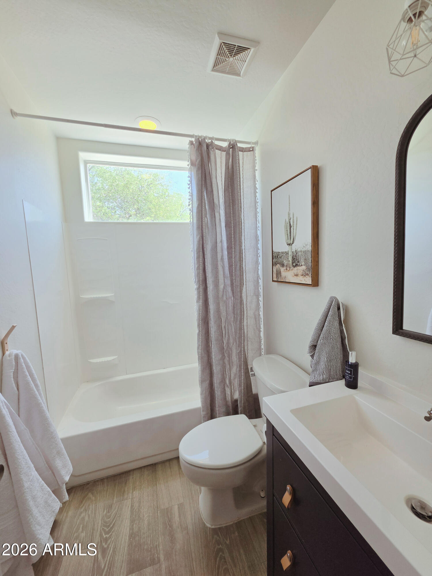 933 West Mercer Lane Phoenix, AZ 85029 - Photo 17 of 46 a bathroom with a sink a toilet and shower